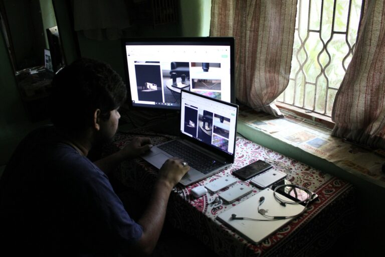 man in black shirt using laptop computer