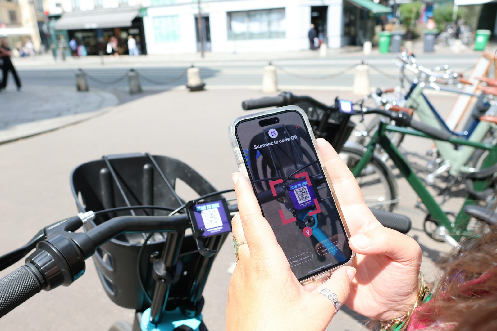 A person on a bike holding a cell phone