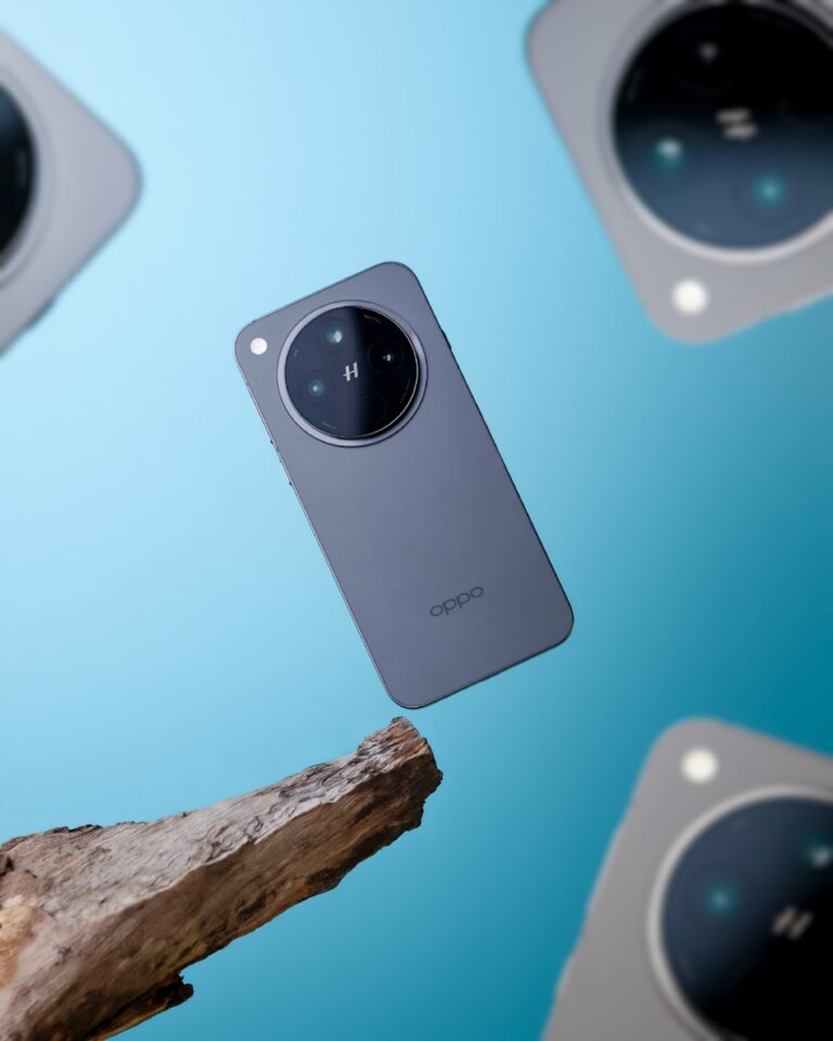 A close up of a cell phone near a tree branch